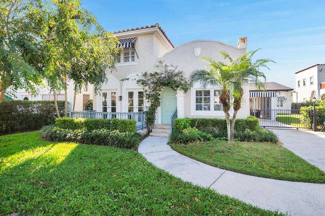 mediterranean / spanish-style home featuring a front lawn