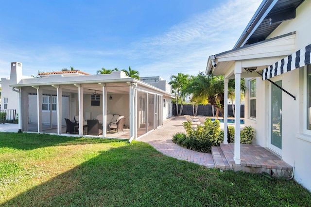 view of yard featuring a sunroom, a patio area, outdoor lounge area, and a pool