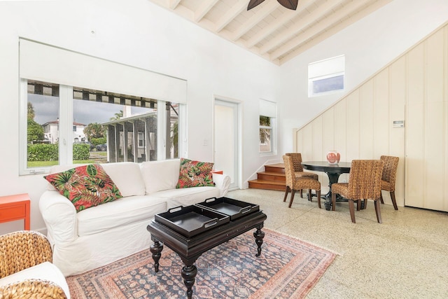 living room featuring beam ceiling, high vaulted ceiling, and plenty of natural light