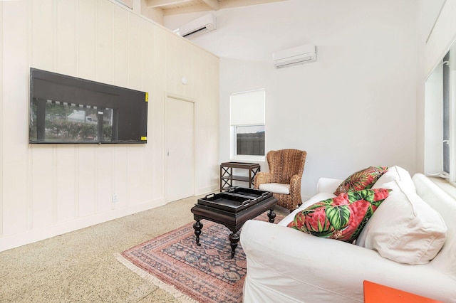 sitting room featuring a wall mounted air conditioner, high vaulted ceiling, and beamed ceiling