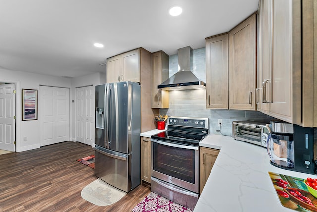 kitchen featuring tasteful backsplash, light stone countertops, appliances with stainless steel finishes, dark wood-type flooring, and wall chimney exhaust hood