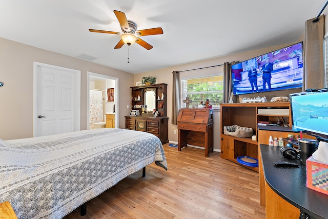 bedroom with ceiling fan, connected bathroom, and hardwood / wood-style flooring