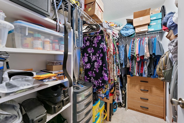 walk in closet with light tile patterned floors