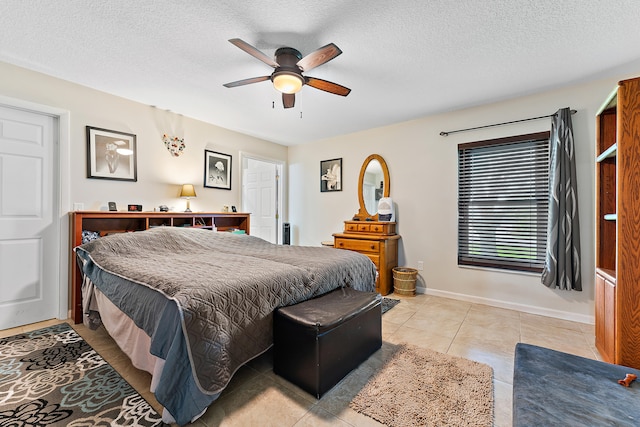 tiled bedroom featuring ceiling fan and a textured ceiling