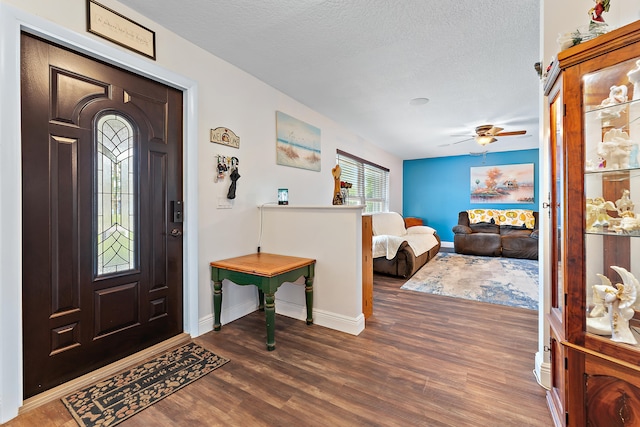 entryway with ceiling fan, a textured ceiling, and dark hardwood / wood-style floors