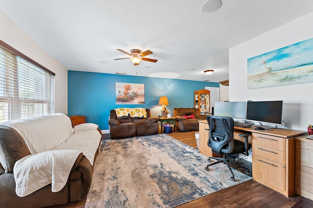 office space with ceiling fan, wood-type flooring, and a textured ceiling