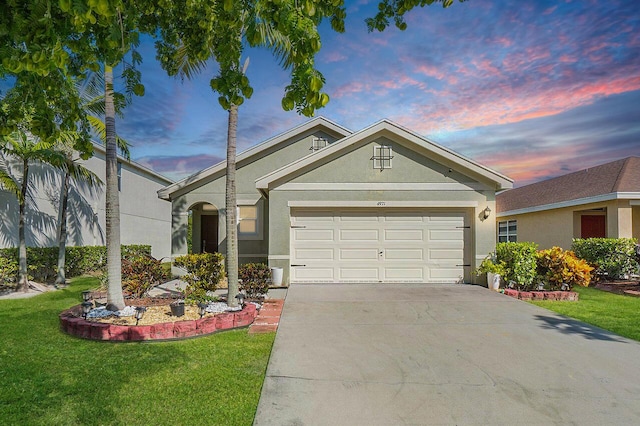 ranch-style home featuring a lawn and a garage