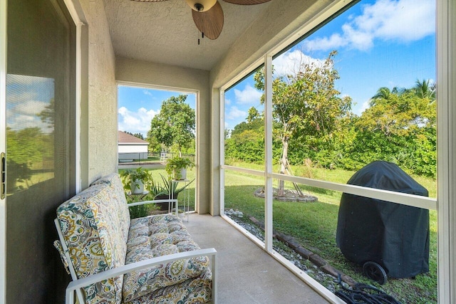 sunroom / solarium featuring ceiling fan