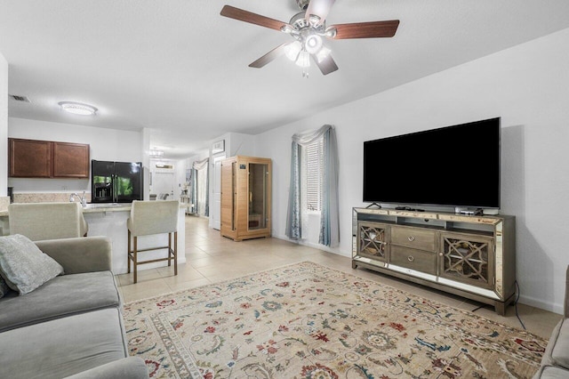 living room featuring ceiling fan and light tile patterned floors