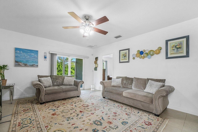 living room with light tile patterned floors, a textured ceiling, and ceiling fan