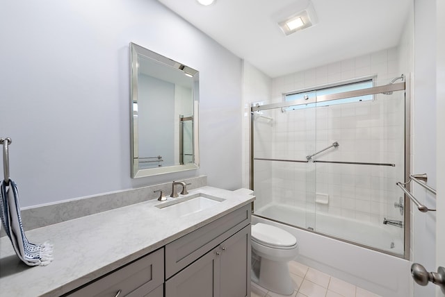 full bathroom with enclosed tub / shower combo, toilet, vanity, and tile patterned flooring