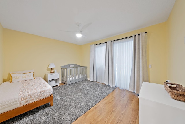 bedroom featuring light wood-type flooring and ceiling fan