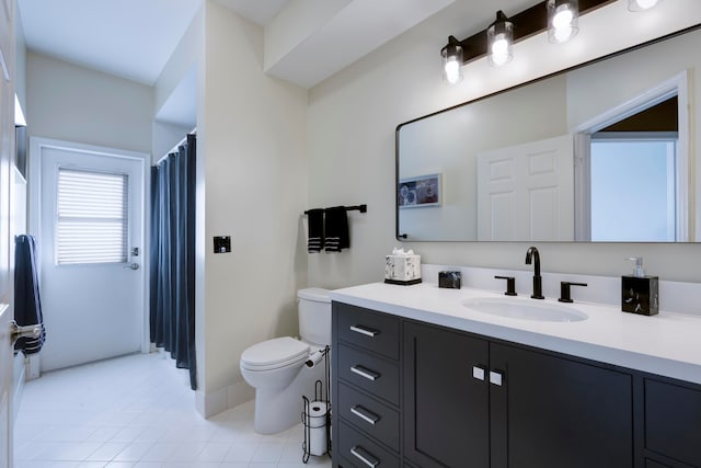 bathroom featuring tile patterned flooring, vanity, and toilet