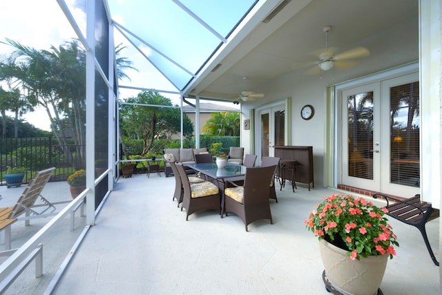 sunroom / solarium featuring french doors and ceiling fan