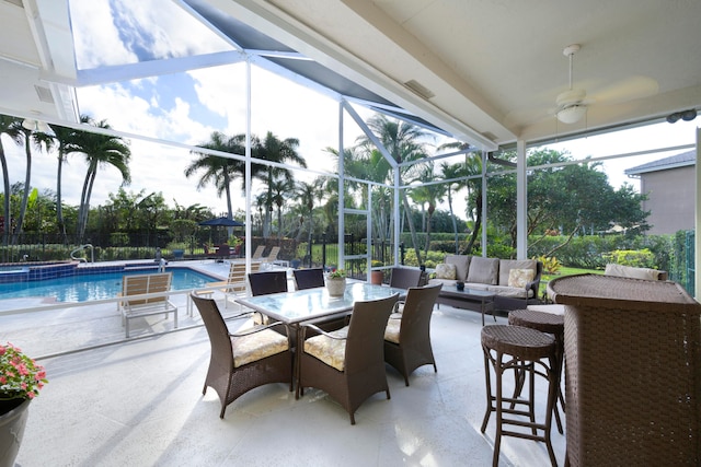 view of patio / terrace featuring outdoor lounge area, a fenced in pool, and glass enclosure