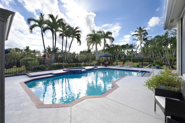 view of swimming pool with a patio area and an in ground hot tub