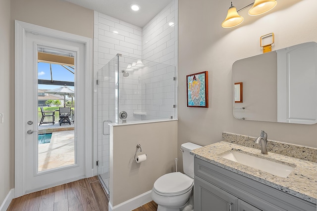 bathroom with vanity, toilet, wood-type flooring, and walk in shower