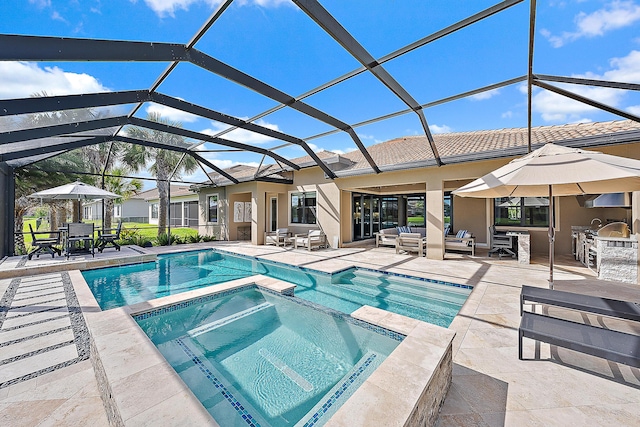 view of swimming pool featuring an in ground hot tub, a patio, an outdoor kitchen, and a lanai