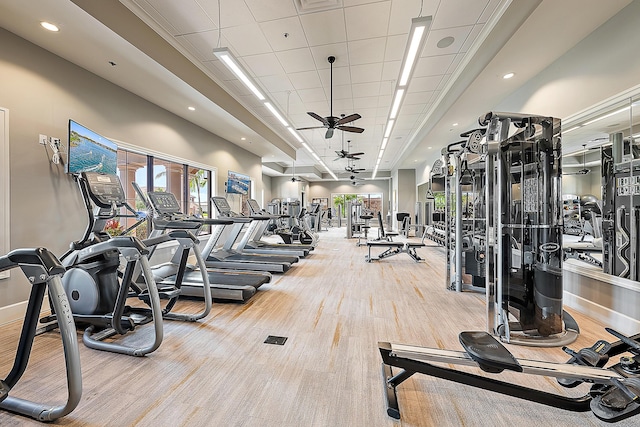 exercise room featuring ceiling fan and light colored carpet