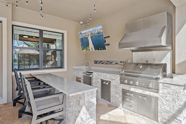 view of patio / terrace featuring area for grilling, exterior kitchen, and a wet bar