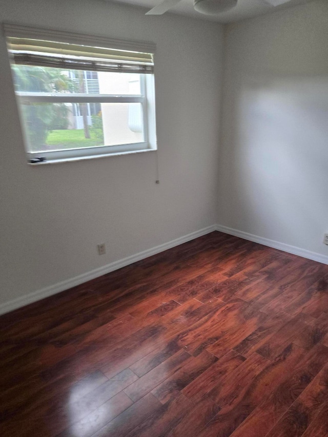 empty room with dark hardwood / wood-style flooring