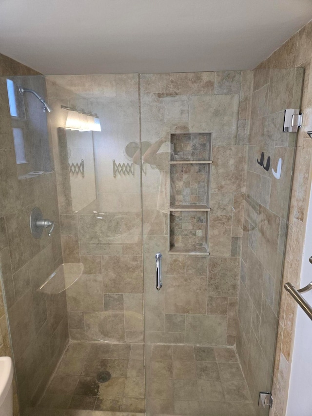 bathroom featuring a shower with shower door