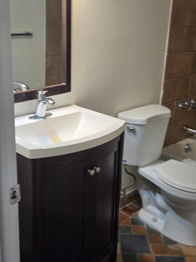 full bathroom with vanity, toilet, and tiled shower / bath