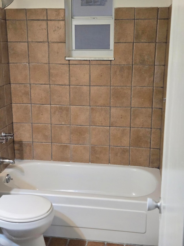 bathroom featuring toilet and  shower combination