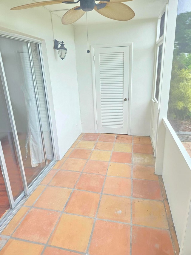 unfurnished sunroom featuring ceiling fan