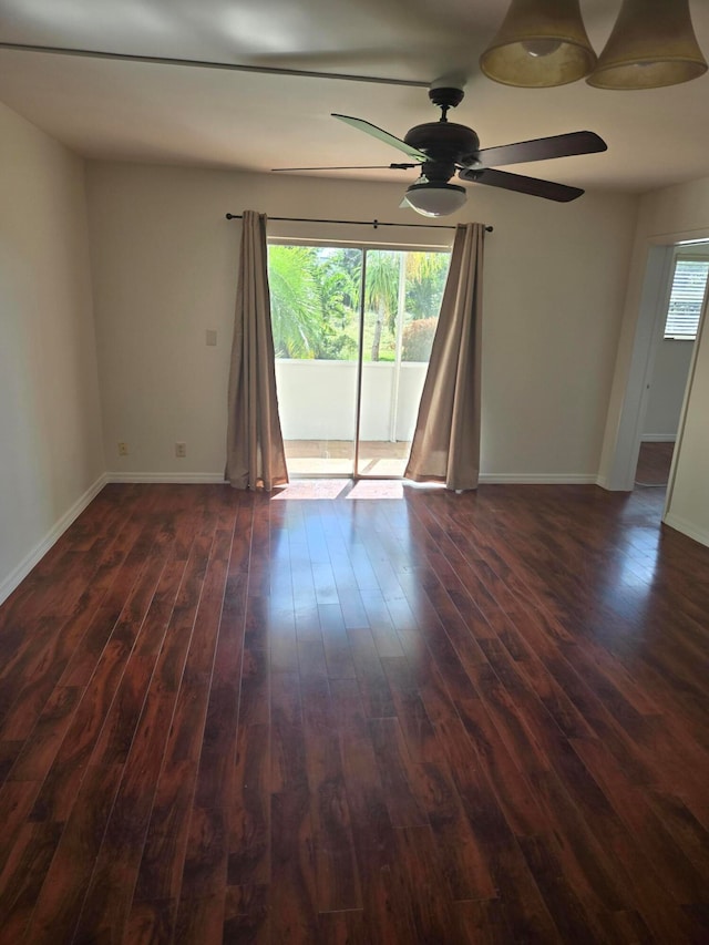 empty room with ceiling fan and dark hardwood / wood-style floors