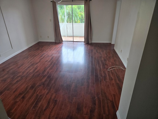 spare room with dark hardwood / wood-style flooring