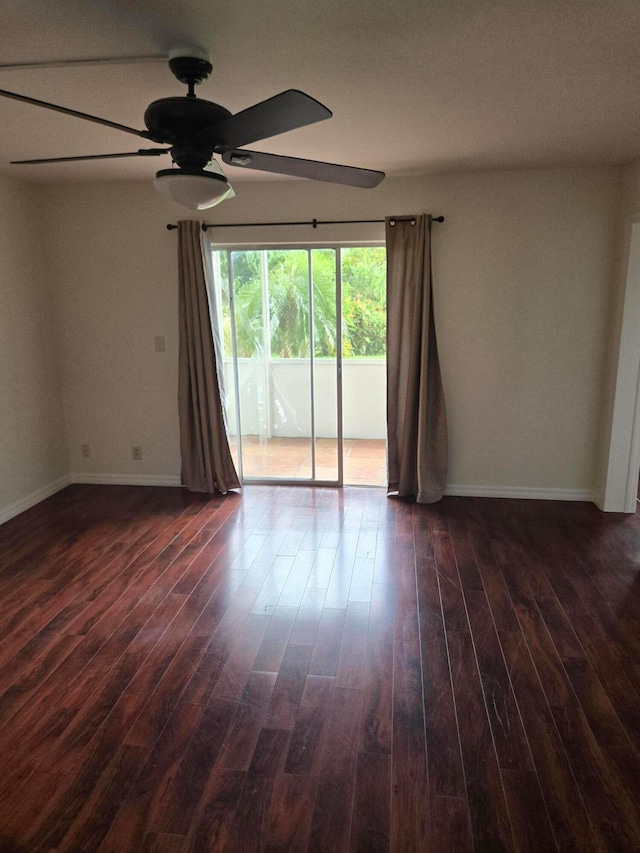 empty room featuring dark wood-type flooring and ceiling fan