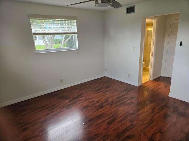 spare room with dark wood-type flooring and ceiling fan