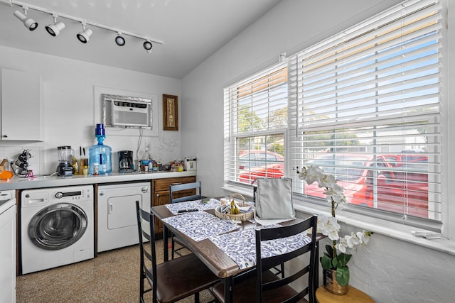 laundry room with washer and dryer, track lighting, and a wall mounted AC