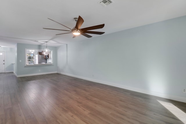 unfurnished room with dark wood-type flooring and ceiling fan with notable chandelier