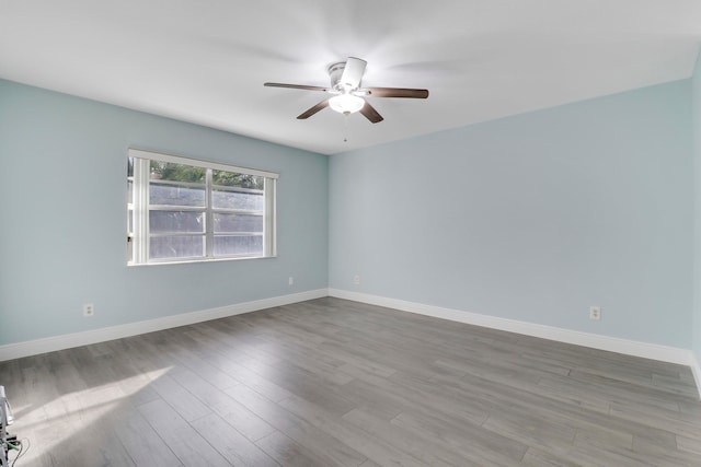 spare room featuring light hardwood / wood-style flooring and ceiling fan