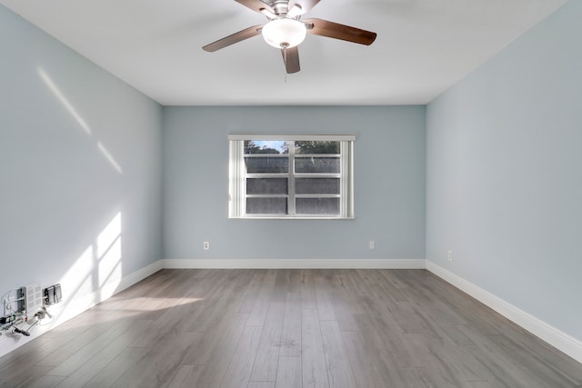 spare room featuring light hardwood / wood-style flooring and ceiling fan