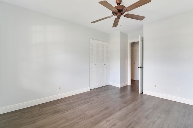 spare room with ceiling fan and dark hardwood / wood-style flooring