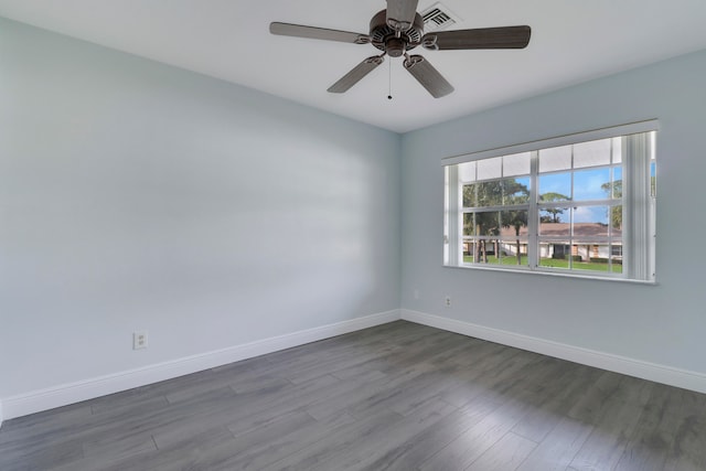 spare room featuring dark hardwood / wood-style floors and ceiling fan