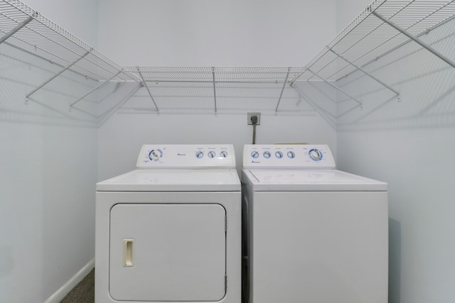 laundry area with washing machine and dryer and carpet