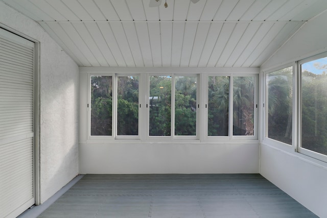 unfurnished sunroom featuring ceiling fan, wood ceiling, and vaulted ceiling