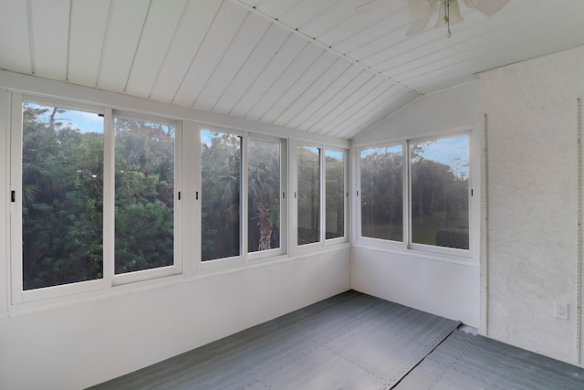 unfurnished sunroom with ceiling fan, lofted ceiling, and a wealth of natural light