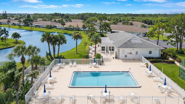 view of swimming pool with a water view and a patio area