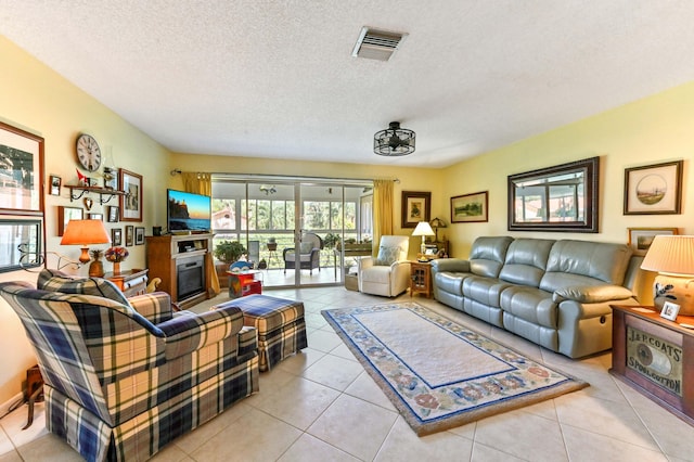 living room featuring a textured ceiling and light tile patterned flooring