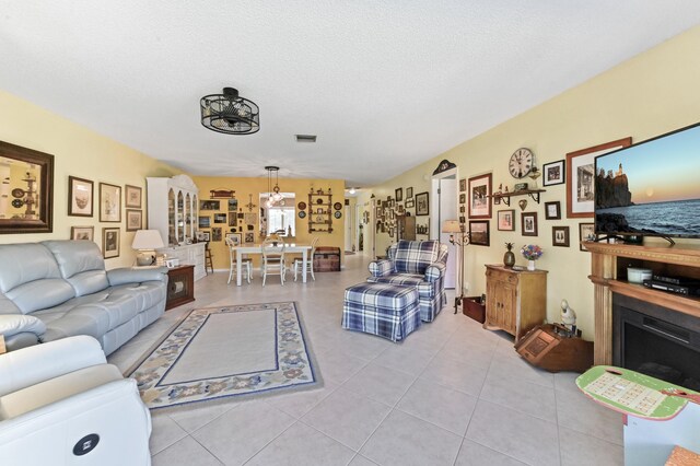 living room featuring light tile patterned floors and a textured ceiling