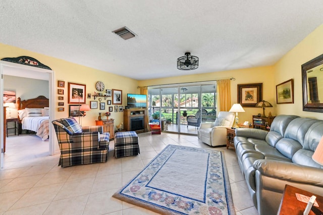 living room featuring light tile patterned floors and a textured ceiling