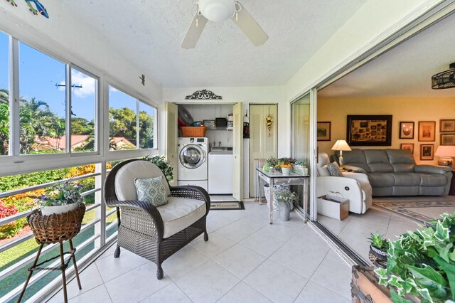 sunroom with ceiling fan and independent washer and dryer