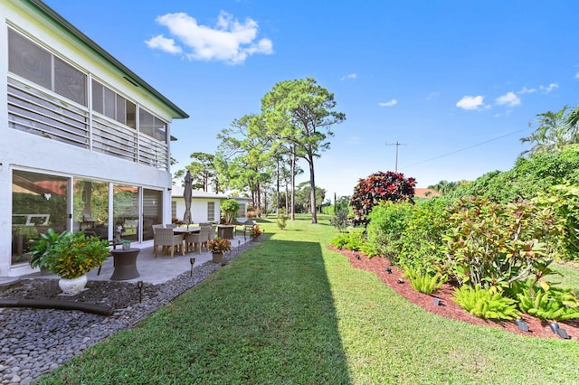 view of yard featuring a patio and a sunroom