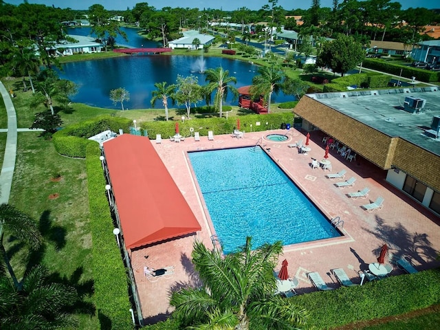 view of pool featuring a patio area and a water view