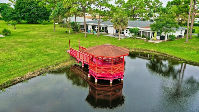 dock area featuring a patio, a water view, and a lawn